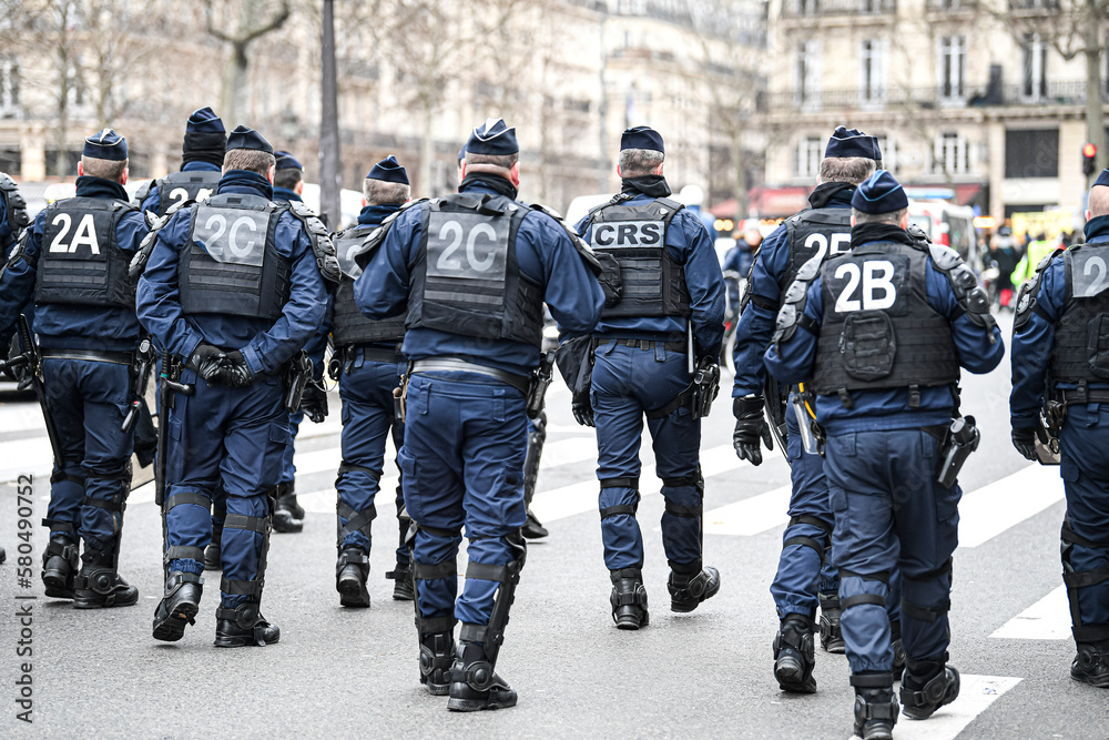 Police men officers (CRS) walk the streets with uniform ensuring security  during a demonstration on March 10, 2023, in Paris, France. Stock Photo |  Adobe Stock