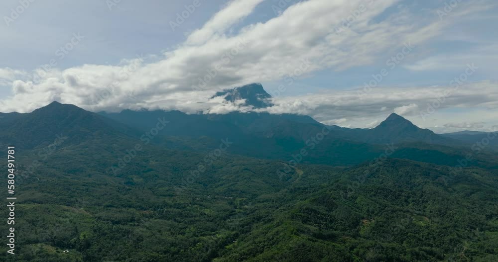 Aerial view of mountain peaks covered with forest. Jungle and mountains. Borneo, Sabah, Malaysia. Aerial view of mountain peaks covered with forest. Jungle and mountains. Borneo, Sabah, Malaysia.