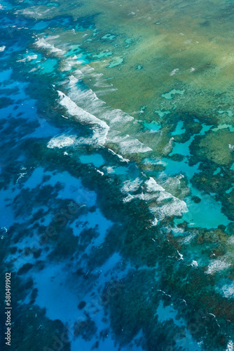 An aerial view of the coral reefs  white sand bars  tropical isles and clear turquoise waters of the Great Barrier Reef     Coral Sea  Cairns  Far North Queensland  Australia 