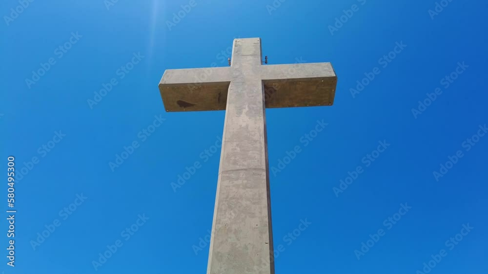 Large Concrete Cross Isolated Against Blue Sky In Mount Filerimos, Rhodes, Greece. - Low-Angle Large Concrete Cross Isolated Against Blue Sky In Mount Filerimos, Rhodes, Greece. - Low-Angle