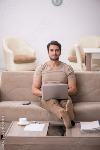 Young male freelancer working from home during pandemic