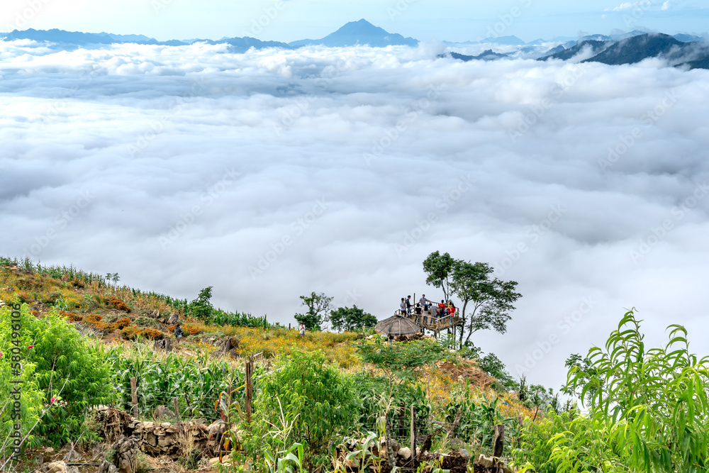 Obraz premium Tourists at Hang Kia-Pa Co. Hang Kia - Pa Co valley is surrounded by four rocky mountains, covered with clouds all year. Hang Kia-Pa Co in Mai Chau district, Son La province, Vietnam