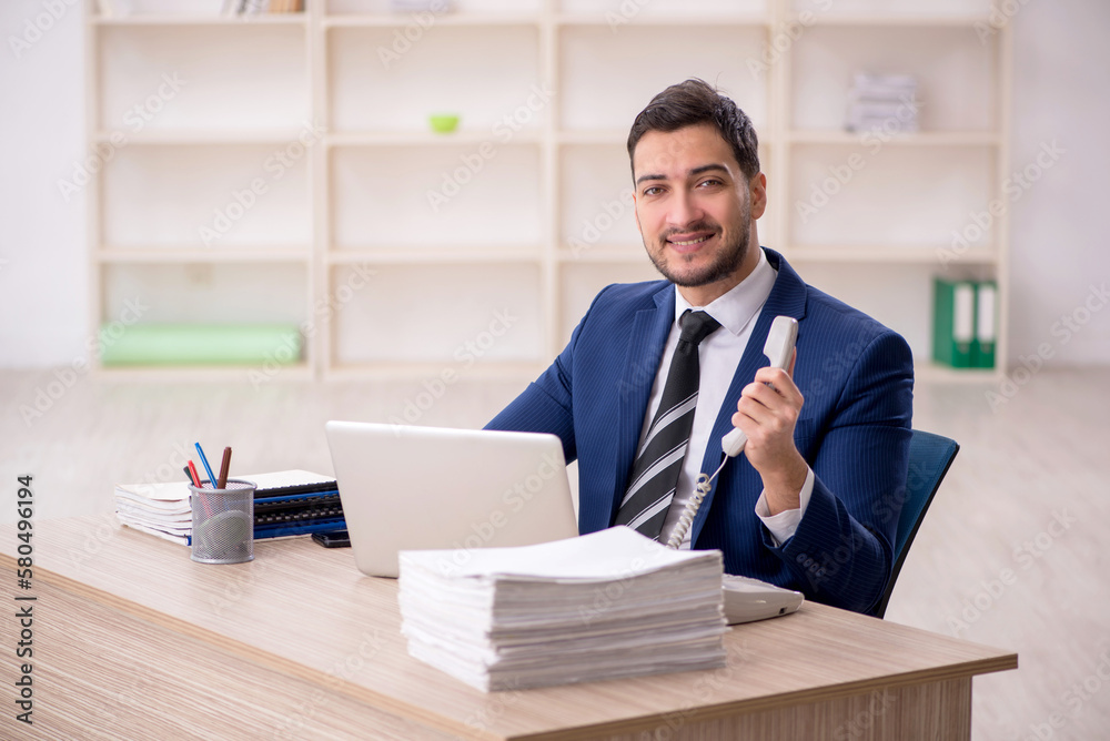 Young male employee working in the office Young male employee working in the office