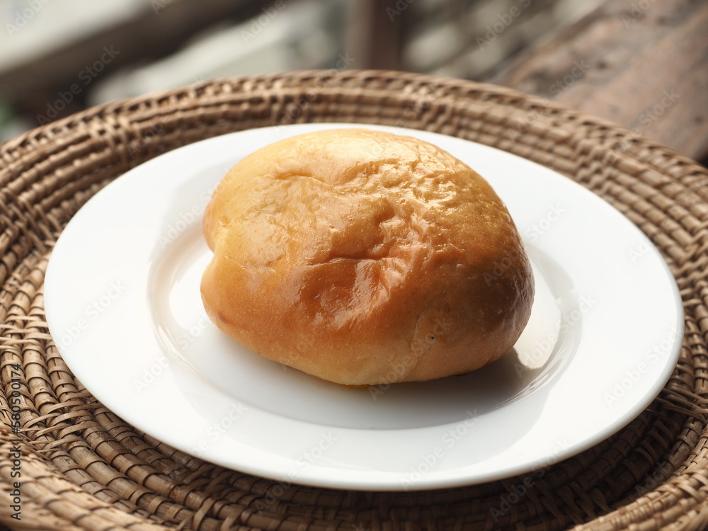 soft bread bun on white dish soft bread bun on white dish
