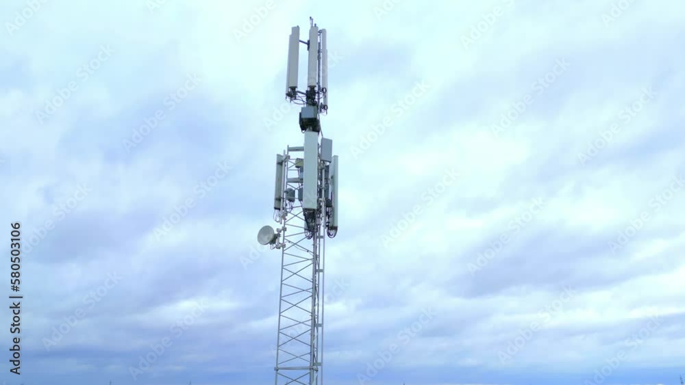 Low Angle Shot Of 5G Telecommunication Tower At Base Station. ascending tilt-down Low Angle Shot Of 5G Telecommunication Tower At Base Station. ascending tilt-down