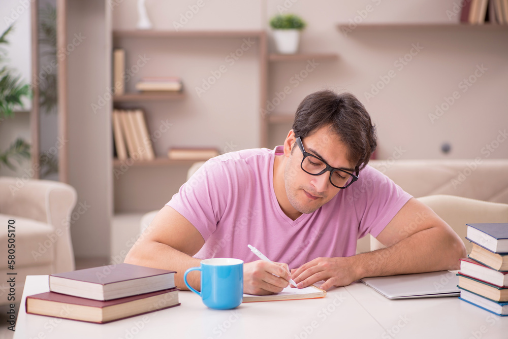 Young male student preparing for exams at home Young male student preparing for exams at home