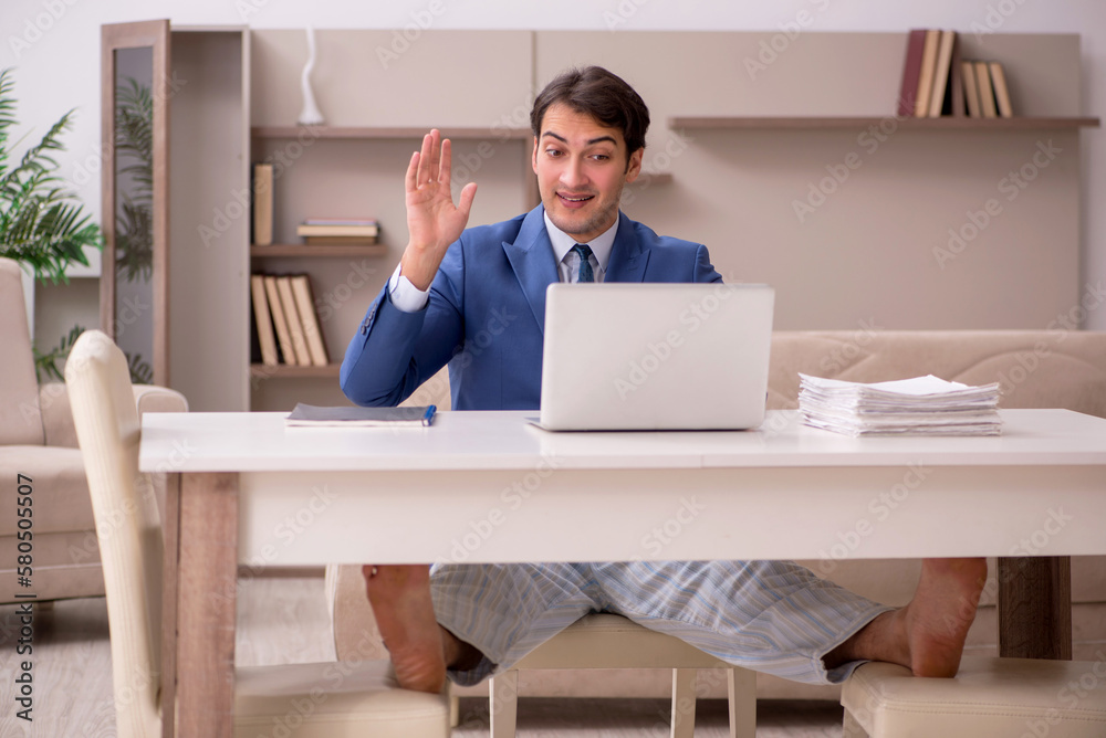Young male employee working from home during pandemic Young male employee working from home during pandemic