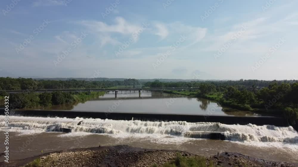 Aerial view of the river and bridge in the morning. Shot forward. Location of the Srandakan Progo River, Yogyakarta, Indonesia