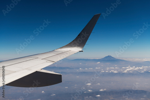 Pico de Orizaba or Citlaltepetl volcano, highest mountain peak of Mexico, seen from airplane with wing.