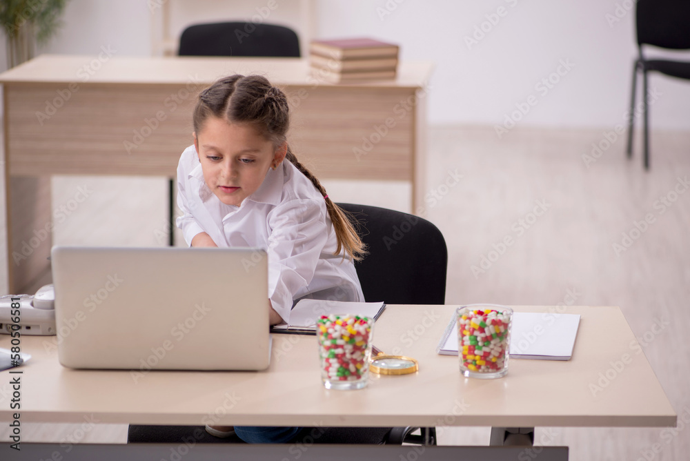 Small girl playing doctor in telemedicine concept Small girl playing doctor in telemedicine concept