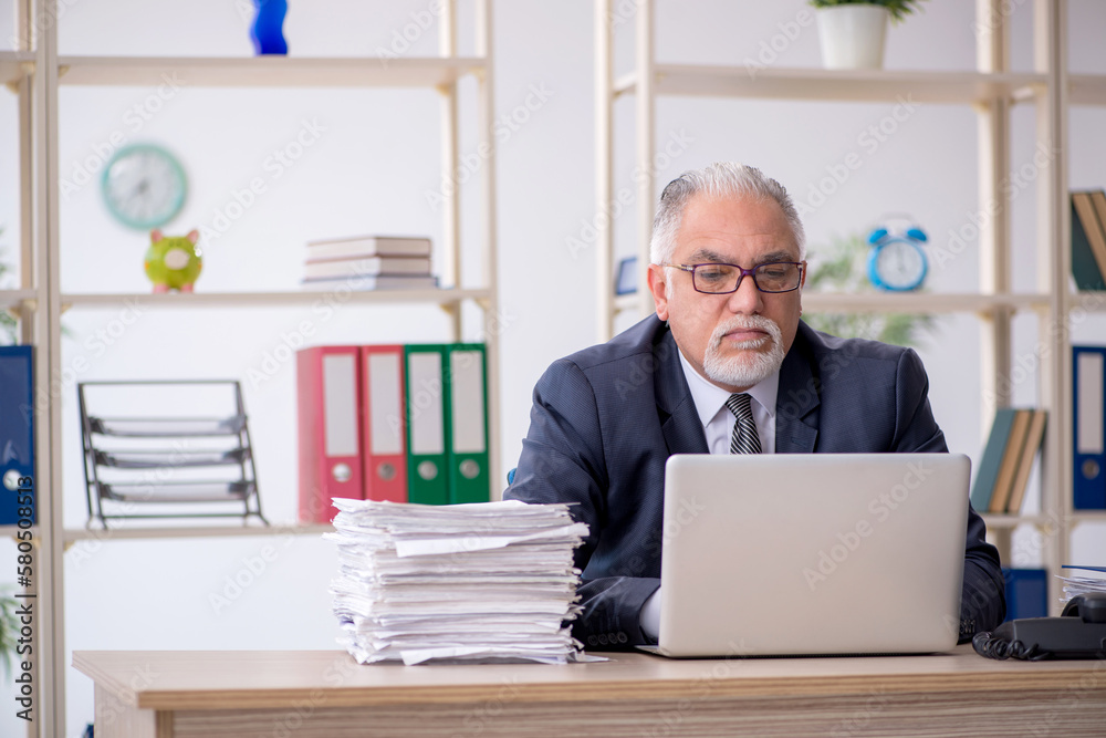 Old male employee and too much work in the office Old male employee and too much work in the office