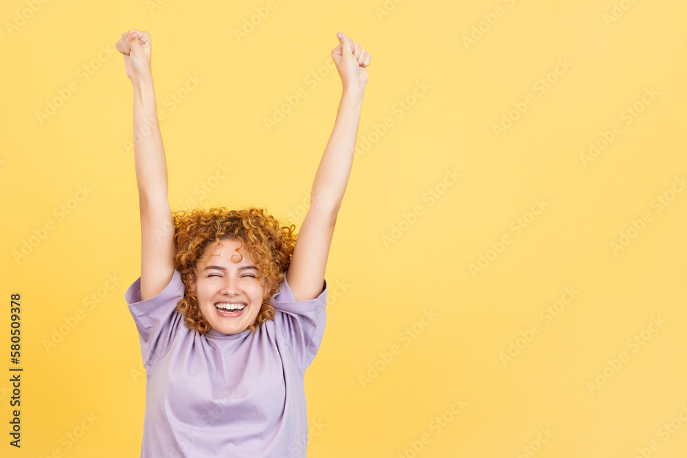 Woman celebrating while raising the arms and smiling Woman celebrating while raising the arms and smiling