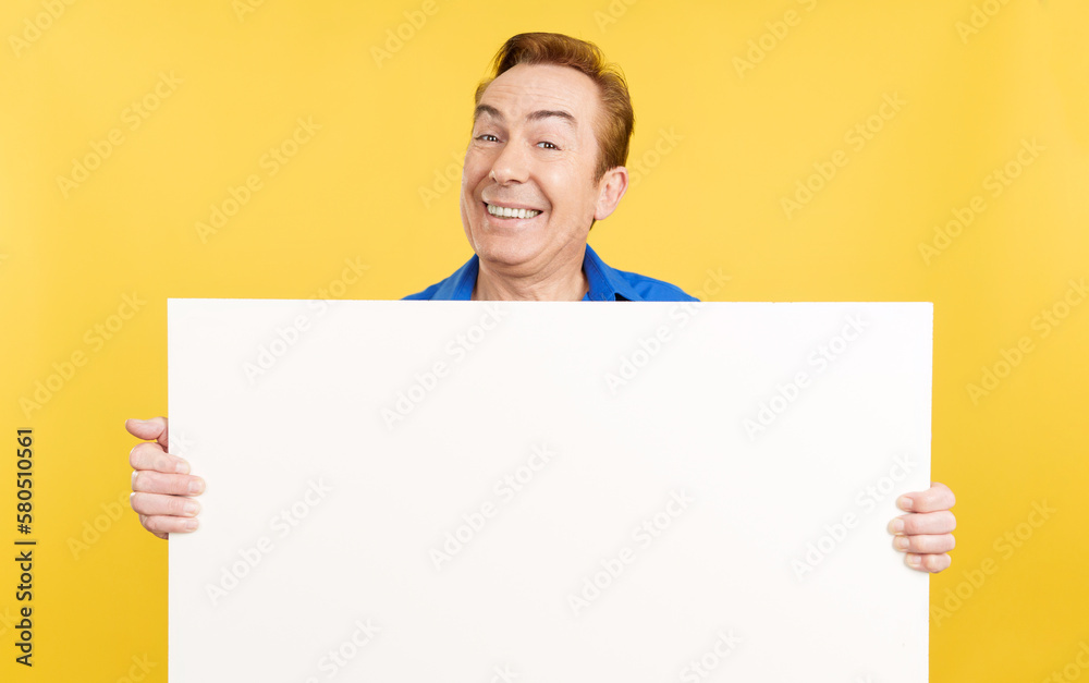 Smiley mature man holding a blank panel Smiley mature man holding a blank panel