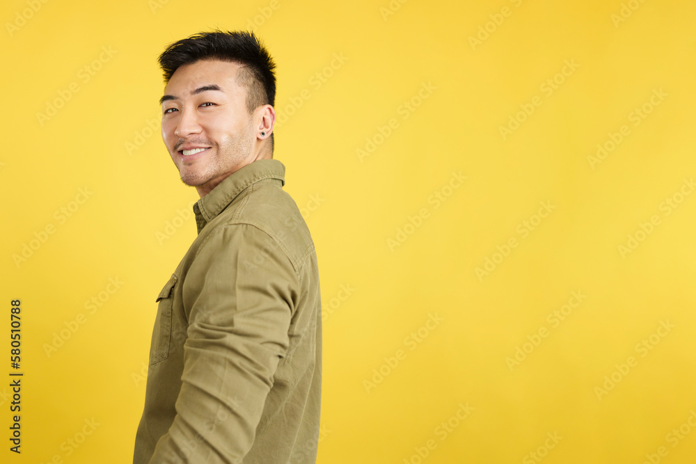 Happy chinese man turning to smile at the camera Happy chinese man turning to smile at the camera