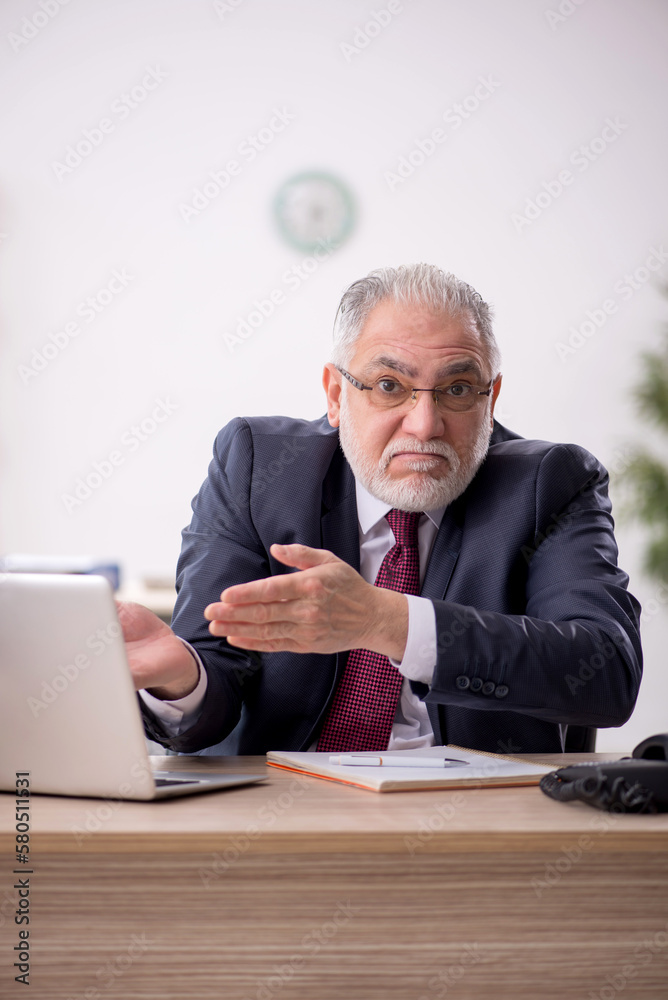 Old male employee and too much work in the office Old male employee and too much work in the office