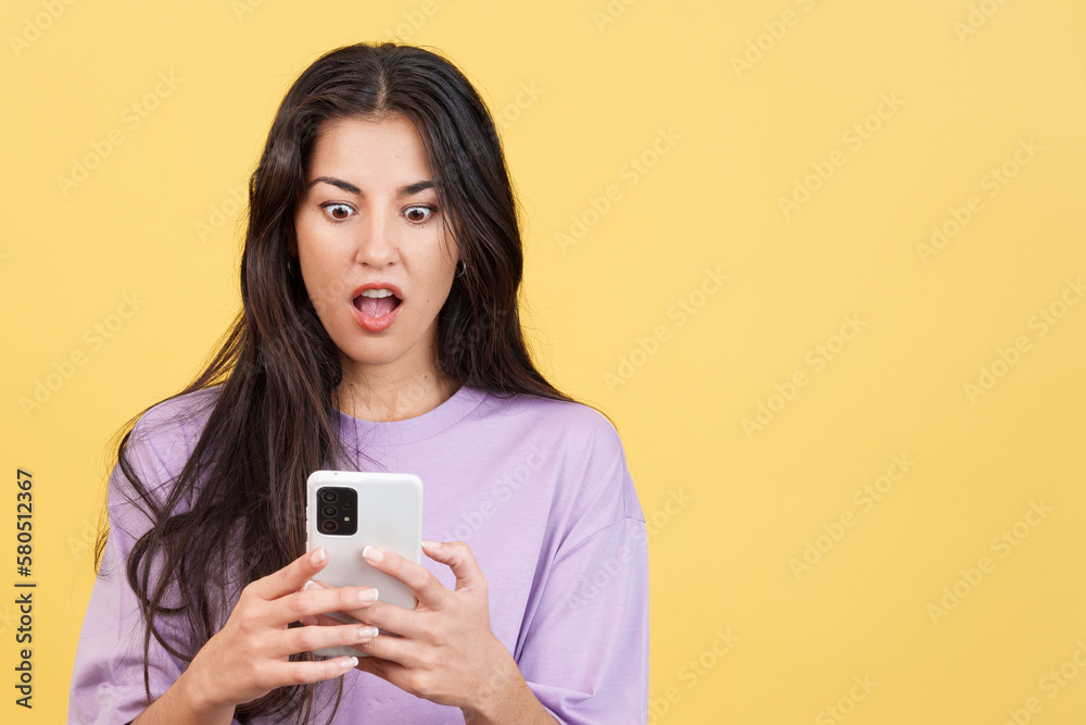 Surprised woman looking the screen of a mobile Surprised woman looking the screen of a mobile
