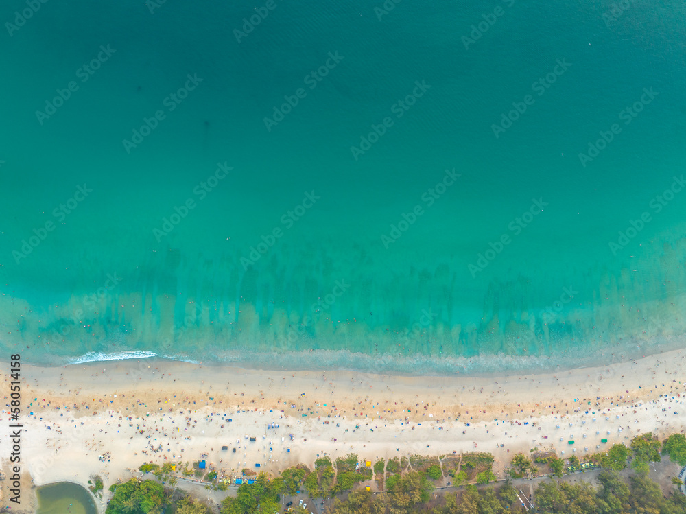 aerial top view above white sand beach. beach crowded with tourists..turquoise sea at Nai Harn beach Phuket. 4k colorful blue sea background..beautiful nature background..