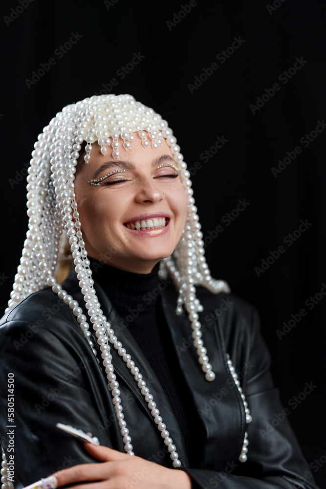 Happy woman with a wig of pearls and make up Happy woman with a wig of pearls and make up