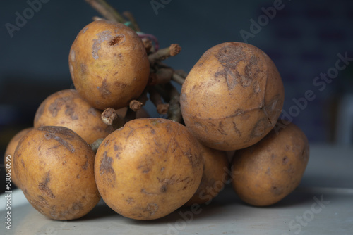 Indonesian fruit is called greater tampoi aka aglaia sp  with white fruit content and light brown fruit skin photo