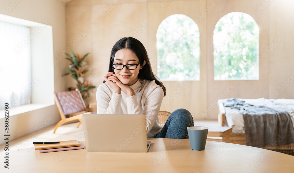 Portrait of nerd sme business asian woman wear glasses work from home at online computer desktop table. Asia freelancer girl using laptop in bed room. Small business sme digital network technology. Portrait of nerd sme business asian woman wear glasses work from home at online computer desktop table. Asia freelancer girl using laptop in bed room. Small business sme digital network technology.