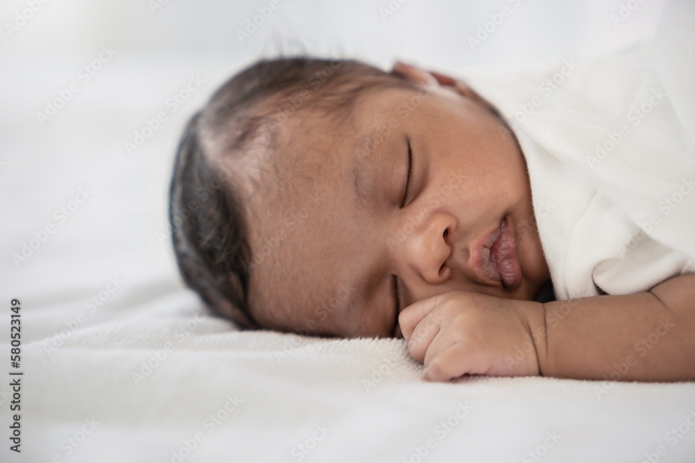 Portrait of close up black African American baby face sleep tight peaceful, hospital daycare nursery for new born baby. Love family healthcare and medical, mother or father's day, love tender concept Portrait of close up black African American baby face sleep tight peaceful, hospital daycare nursery for new born baby. Love family healthcare and medical, mother or father's day, love tender concept
