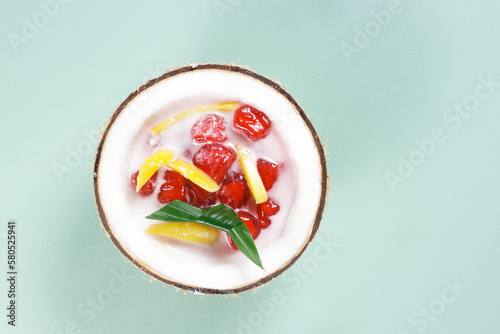 Thai Dessert Called Tub Tim Krob or Thai Red Ruby Dessert - made from Water Chestnut Coated with Flour served in Coconut Milk. photo