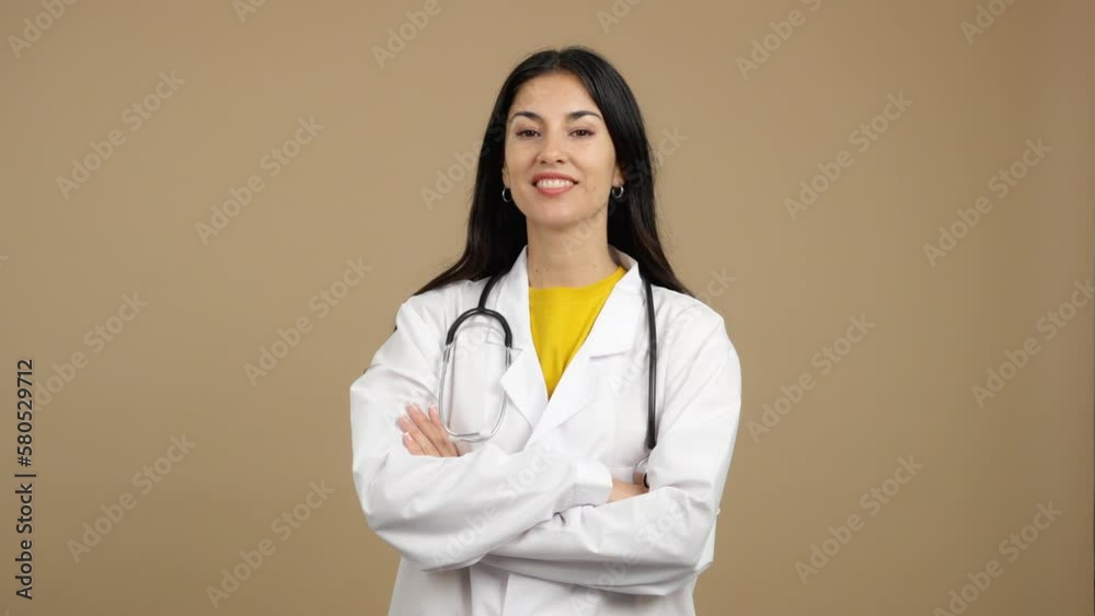 Caucasian female doctor smiling at the camera with arms crossed Caucasian female doctor smiling at the camera with arms crossed