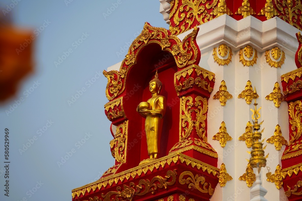 Buddha statue, standing, golden, decorated on the pagoda