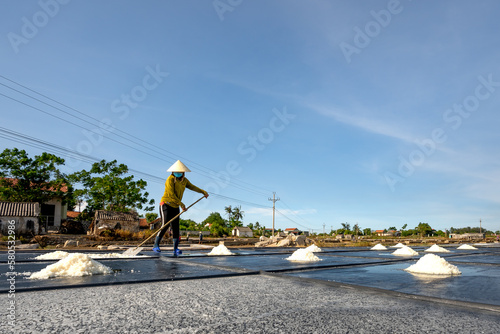 a woman making salt in Nghe An province, Vietnam photo