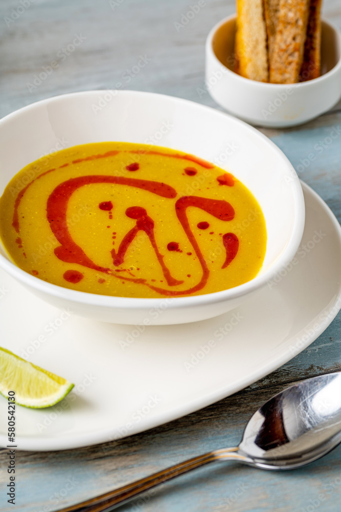 Strained lentil soup on a white porcelain plate Strained lentil soup on a white porcelain plate