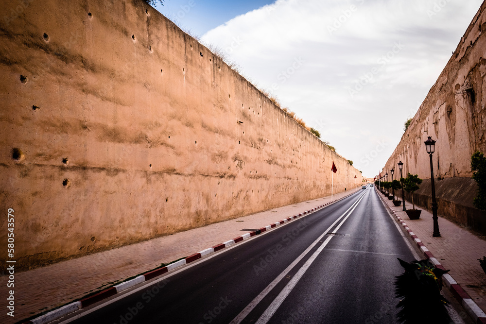 Road by walls in city