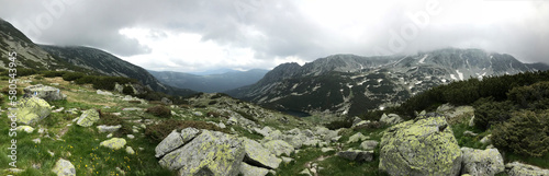 Panoramic view of mountains against cloudy sky at Retezat National Park photo
