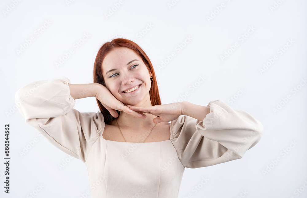 portrait of a young beautiful woman touching her face on white background, copy space