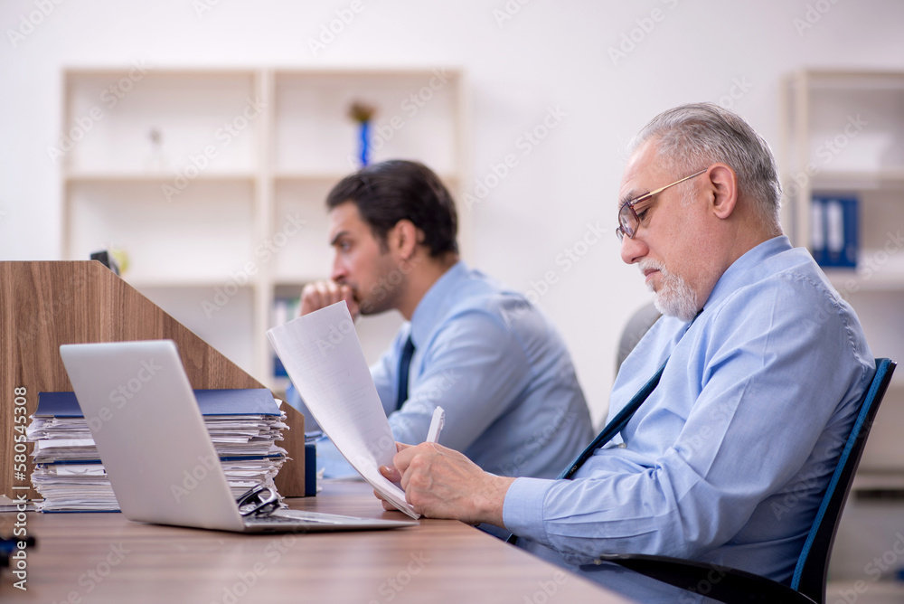 Two male colleagues working in the office Two male colleagues working in the office