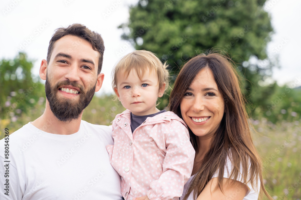 Family looking at camera standing in a rural path Family looking at camera standing in a rural path