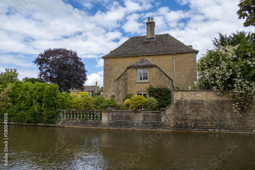 Burton on Water, UK, 28 june 2022. Wide angle views of the typical houses with shallow river in burton on the water small village in the Cotswold.