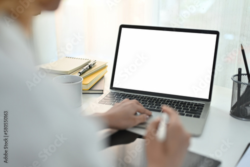 Businessman using laptop contact business, search information on office desk. Empty screen for marketing and creative design