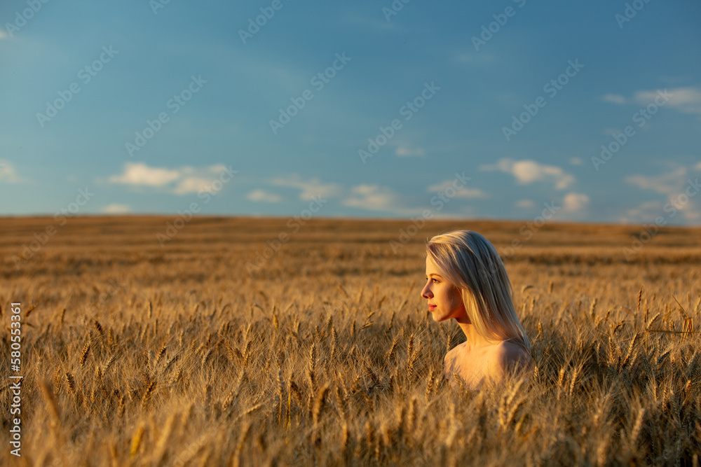 Blonde woman without clothes in wheat field in sunset time Blonde woman without clothes in wheat field in sunset time