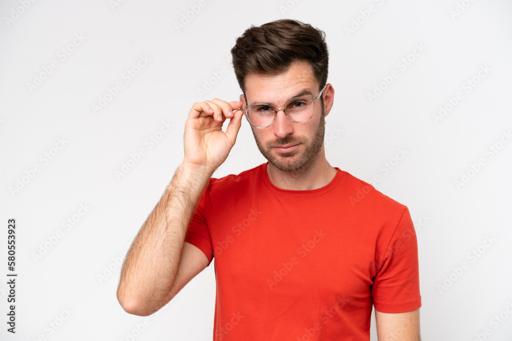 Young caucasian man isolated on white background With glasses and frustrated expression Young caucasian man isolated on white background With glasses and frustrated expression