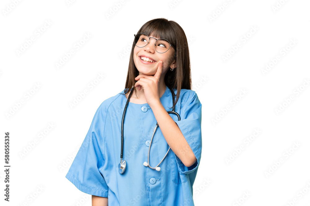 Little girl as a surgeon doctor over isolated chroma key background thinking an idea while looking up Little girl as a surgeon doctor over isolated chroma key background thinking an idea while looking up