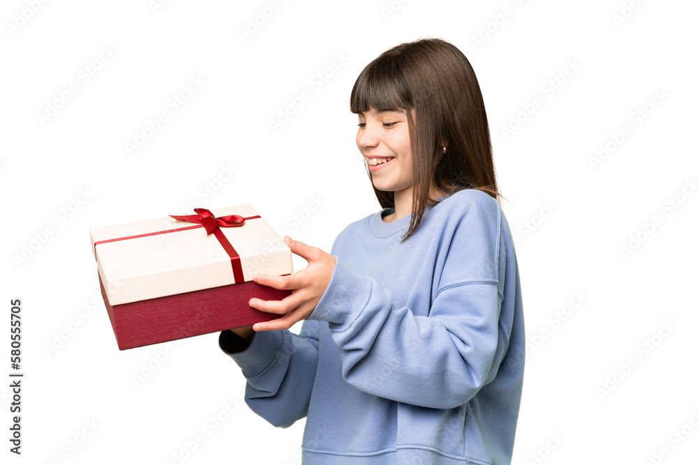 Little girl holding a gift over isolated chroma key background with happy expression Little girl holding a gift over isolated chroma key background with happy expression