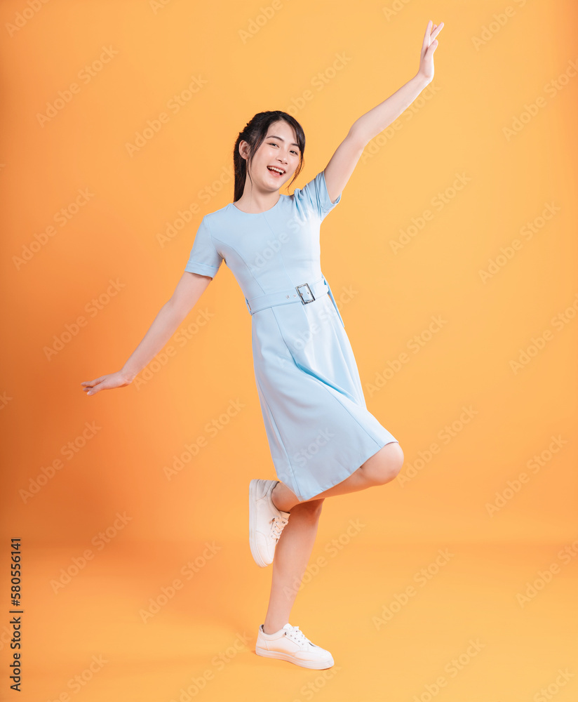 Young Asian woman wearing dress on background Young Asian woman wearing dress on background