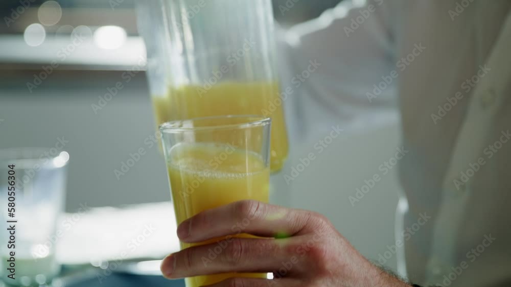 Pouring in orange juice, closeup Pouring in orange juice, closeup