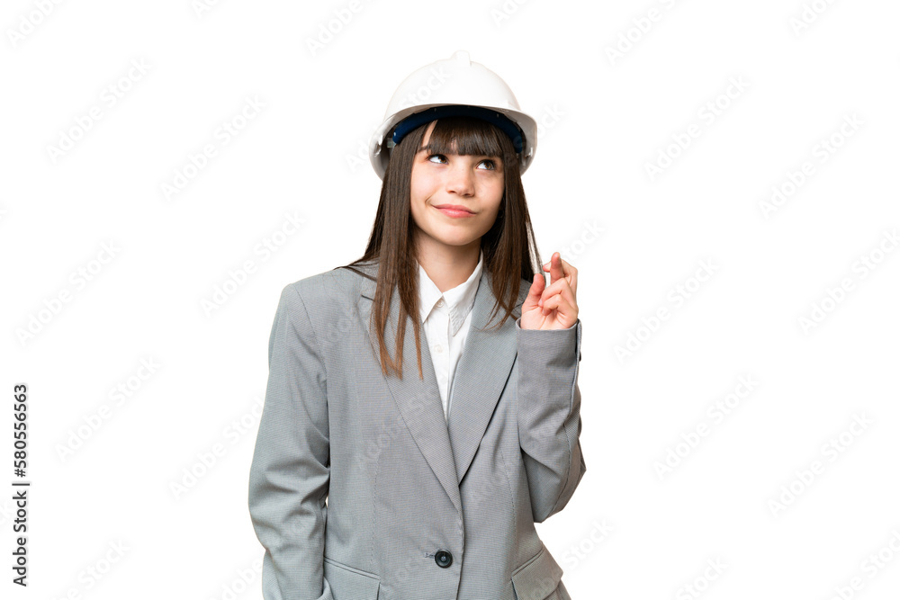Little girl playing as a architect with helmet and holding blueprints over isolated background with fingers crossing and wishing the best