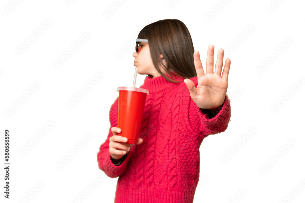 Little girl holding soda over isolated chroma key background making stop gesture and disappointed Little girl holding soda over isolated chroma key background making stop gesture and disappointed