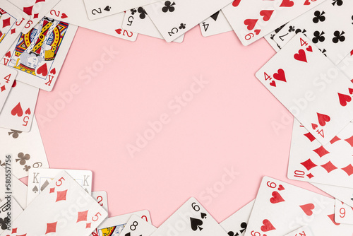Poker playing cards on pink background