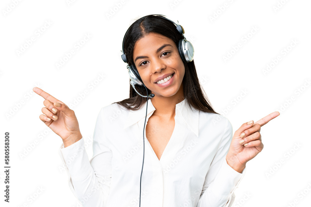 Telemarketer African American woman working with a headset over isolated chroma key background pointing finger to the laterals and happy Telemarketer African American woman working with a headset over isolated chroma key background pointing finger to the laterals and happy