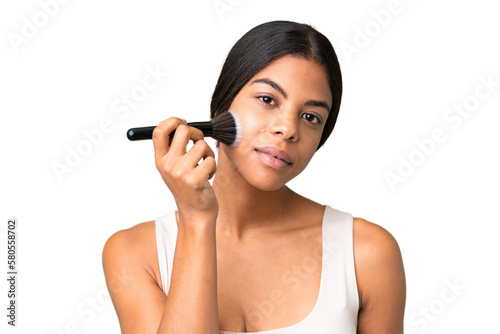 Young woman over over isolated chroma key background holding makeup brush