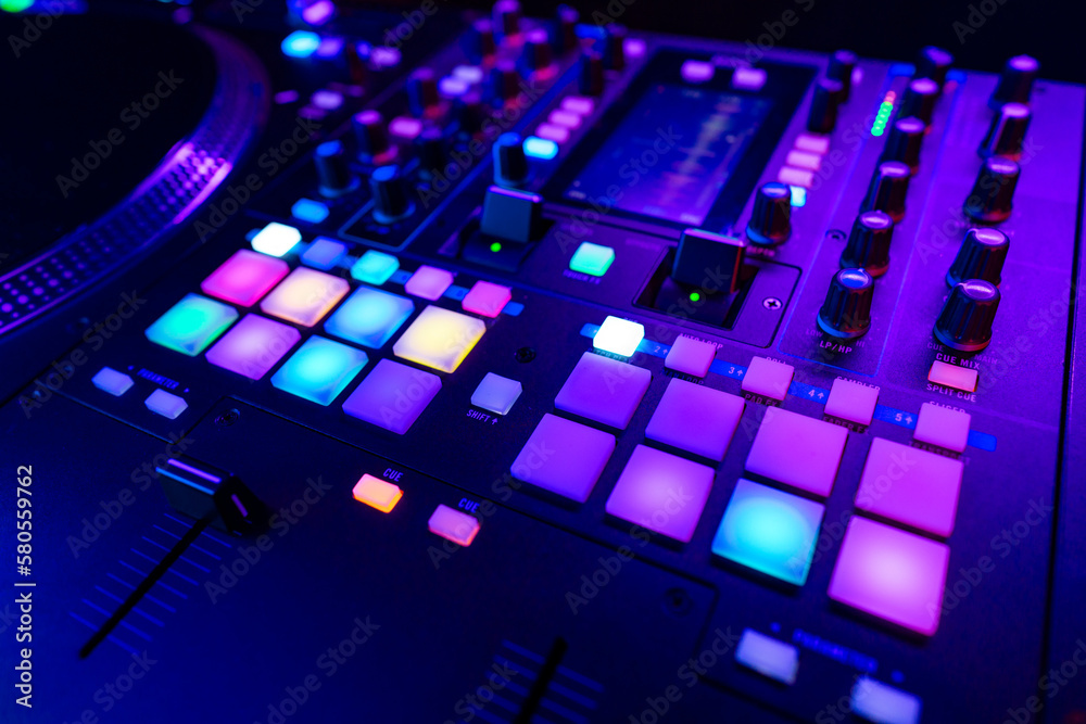 Close up of DJ mixing console in party light Stock-Foto | Adobe Stock