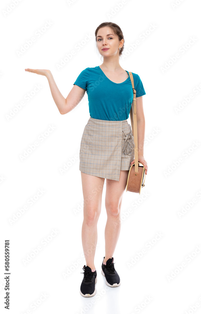 Full-length portrait of cute woman holding something on her hand and posing in studio. Adorable twenty year old girl presentation and smiling on camera, isolated on white background. Full-length portrait of cute woman holding something on her hand and posing in studio. Adorable twenty year old girl presentation and smiling on camera, isolated on white background.